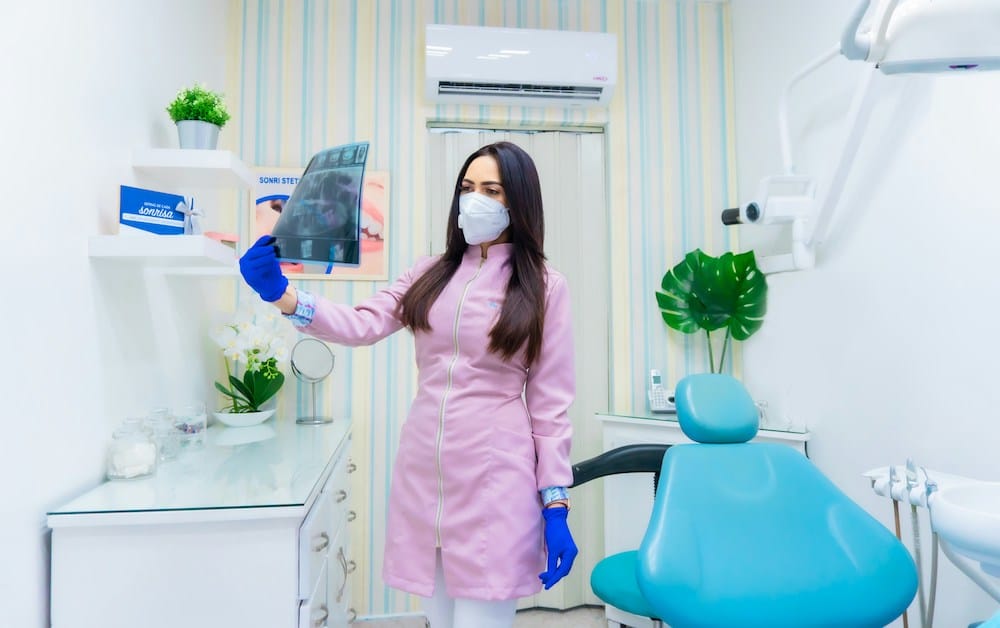 Dentist looks at x-ray
