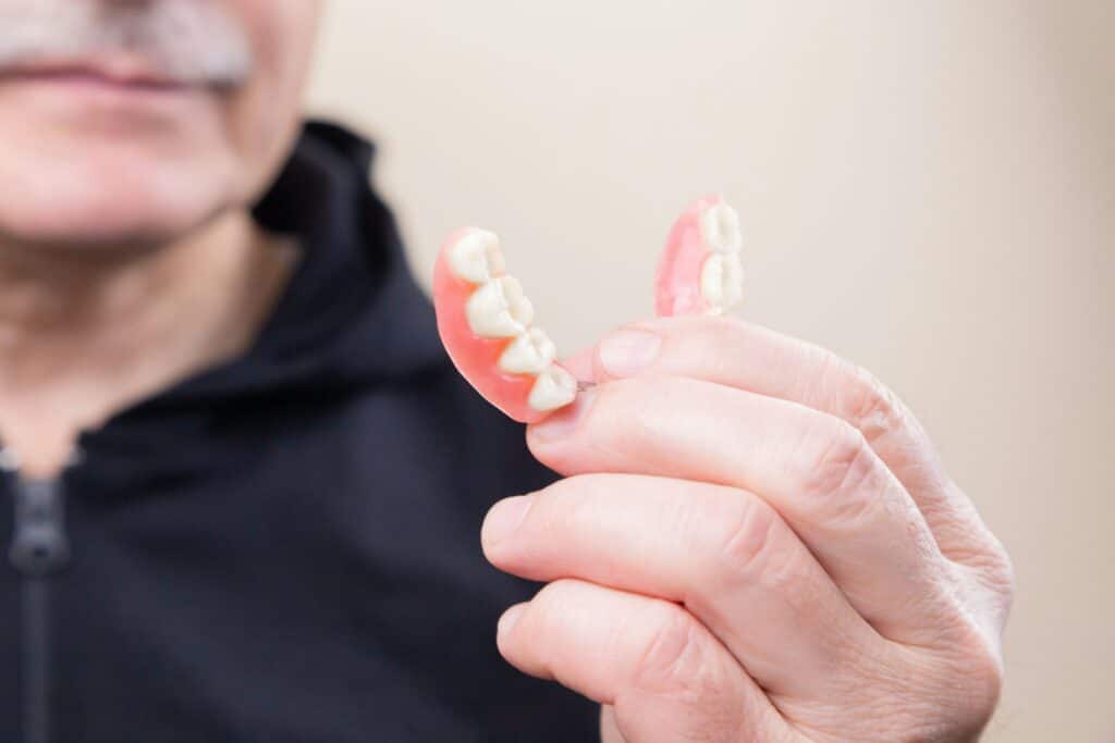 Man holding denture