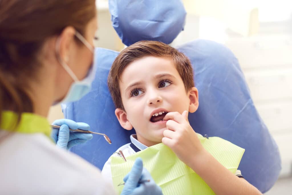 A child with a dentist in a dental office