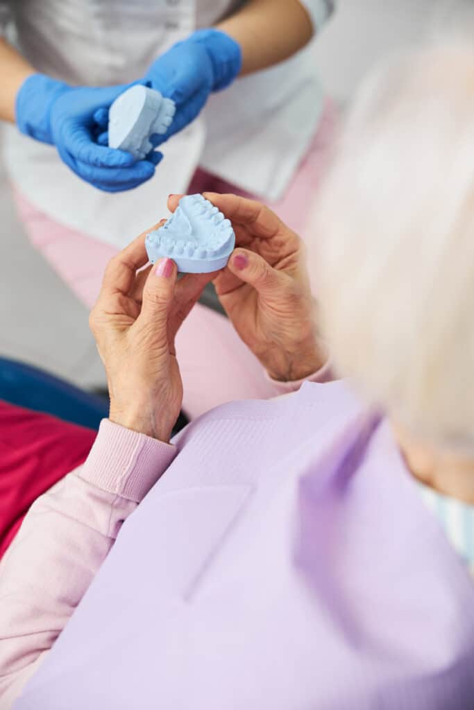 Lady holding dental impression