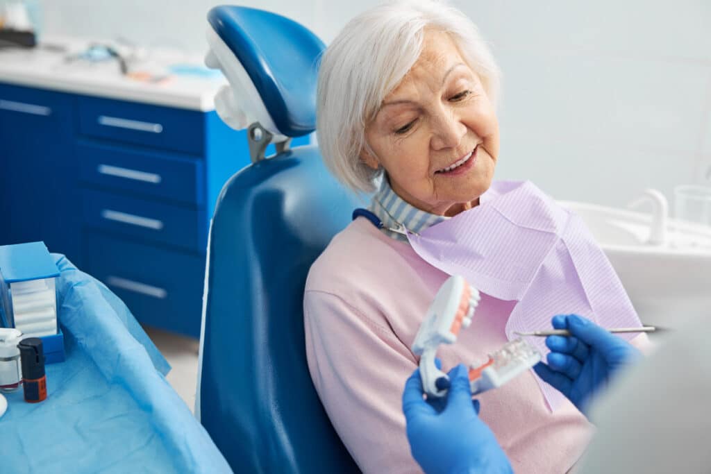 Senior lady looking at dentures