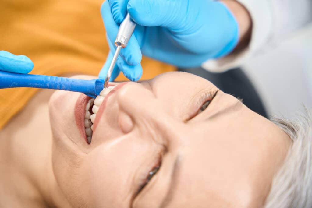 Mature lady getting dental treatment